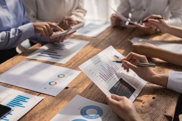 Meeting in a business presentation or seminar Group of business people working with docu